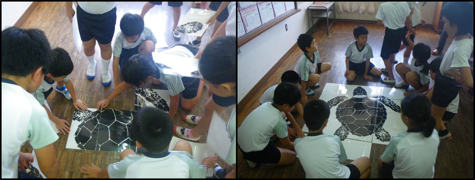 アカウミガメの実物大パズルを組み立てる児童の様子